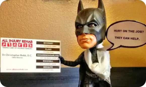 batman figure holding a clinic sign