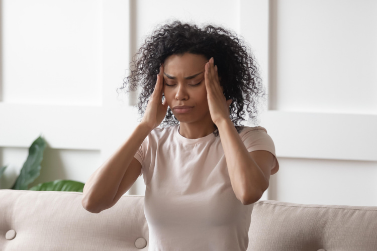 a woman feels a headache 