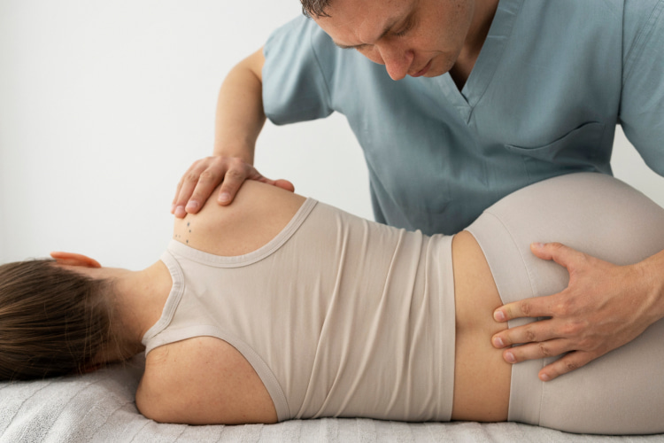 a woman uses chiropractic treatment for herniated disc