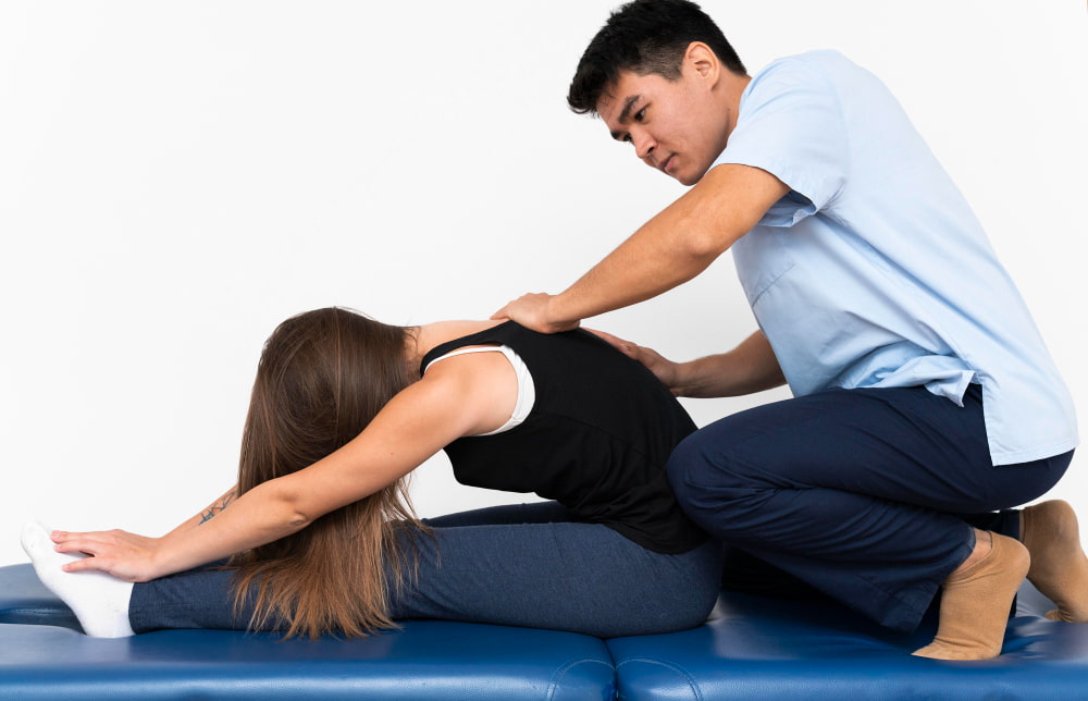 chiropractor is helping a woman with stretching